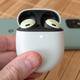 The Google Pixel Buds Pro inside their egg-shaped charging case.